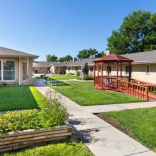 A well-maintained residential courtyard featuring a garden, gazebo, and walkways.