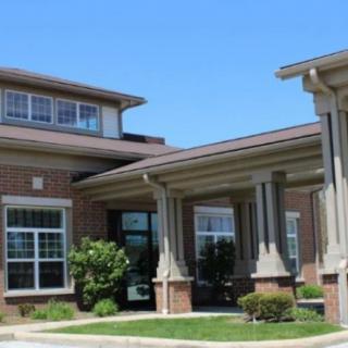A modern residential building with large windows and brick exterior.