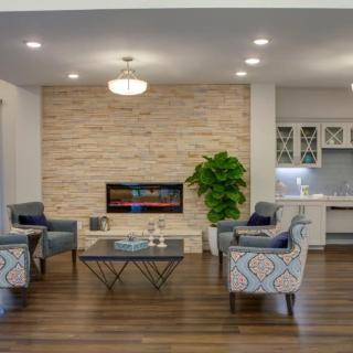 A modern living room with a sleek fireplace, stylish furniture, and contemporary decor.