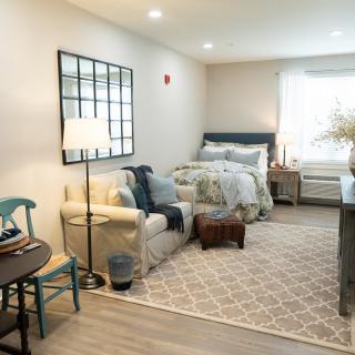 A cozy and modern bedroom with a comfortable seating area and stylish decor.