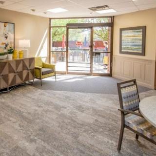 A bright and inviting lobby space featuring modern furniture and large windows.