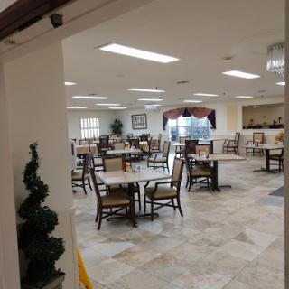 A spacious dining area featuring tables and chairs arranged for customers.