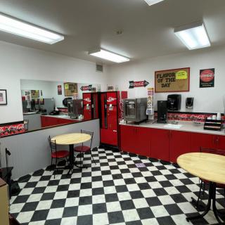 A retro-style diner with a checkered floor and red decor.