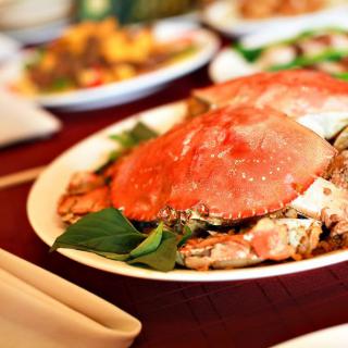 A deliciously prepared crab served on a plate, ready to be enjoyed.