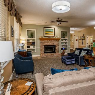 Cozy living room with a fireplace, comfortable seating, and elegant decor.