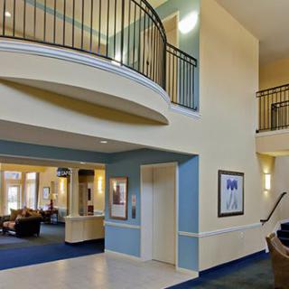 Modern lobby area with stairs and elevator.