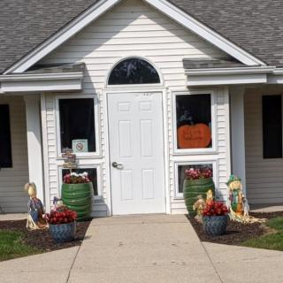 A house entrance decorated with autumn-themed elements.