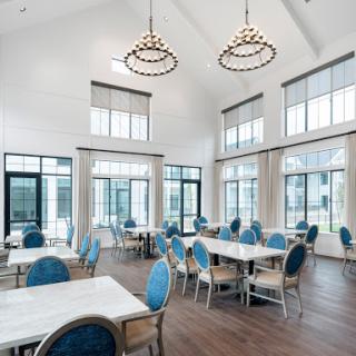 A modern dining area featuring stylish furniture and ample natural light.