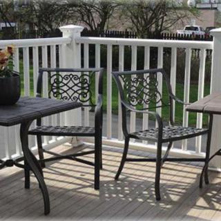 Outdoor patio set with two chairs and a table on a wooden deck.