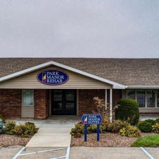 The image shows a medical clinic building with a clear entrance and signage.