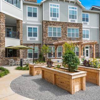 Modern apartment complex featuring landscaped outdoor areas.