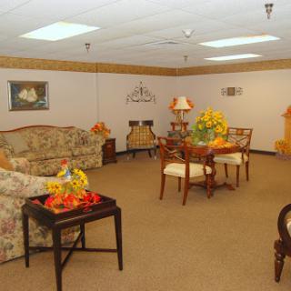 A cozy and inviting living room setup with floral-patterned furniture and warm decor.