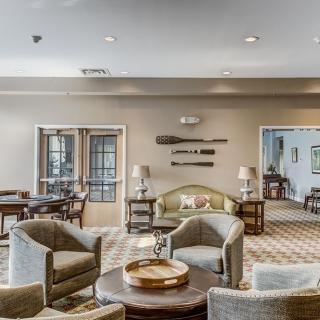 A spacious and elegantly designed lounge area with modern furniture and decor.