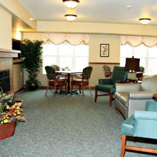 A cozy living room with seating area and fireplace.