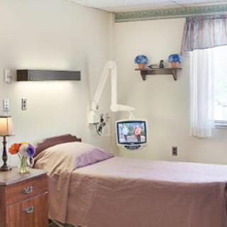 A hospital room with a patient bed and medical equipment.