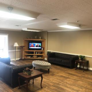A cozy living room setup featuring comfortable sofas and a television.