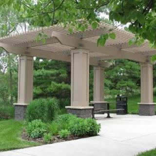A gazebo in a peaceful park surrounded by lush greenery.