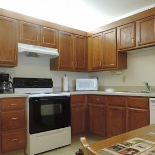 A well-organized kitchen featuring wooden cabinets and essential appliances.