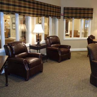 A cozy living room with leather chairs and soft lighting.