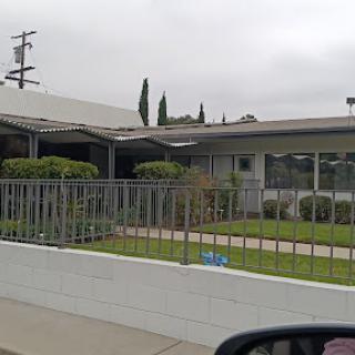A view of a suburban house with a neatly trimmed lawn and modern architecture.