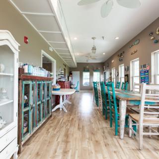 A bright dining area with vintage decor and wooden flooring.