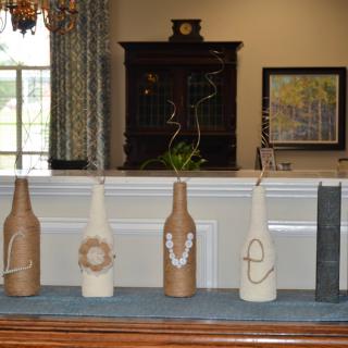 Decorative bottles spelling 'LOVE' displayed on a shelf.