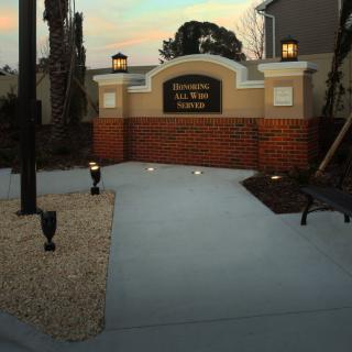 Entrance to the La Belle Vida community with decorative lighting and landscaping.