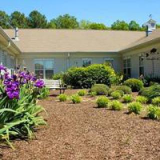 A well-maintained courtyard garden featuring flowers and shrubs.