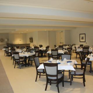 A neatly arranged dining area in a restaurant with set tables and chairs.