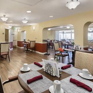 A well-arranged dining room with neatly set tables and ambient lighting.