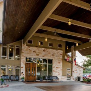 Entrance to a building with a brick facade and wooden ceiling.