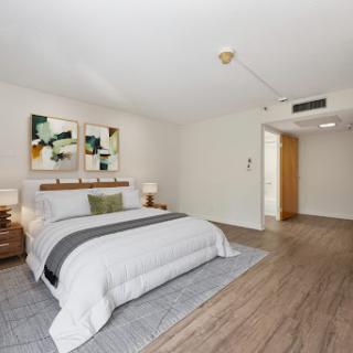 A stylish and modern bedroom featuring minimalist decor and contemporary artwork.