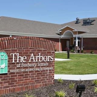 A nursing facility named 'The Arbors' with a welcoming entrance and a well-maintained garden.