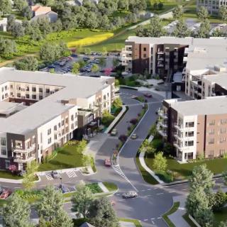 Aerial view of a modern residential apartment complex with surrounding greenery.