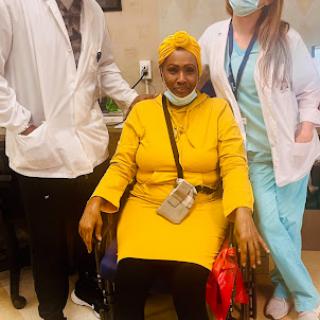 A cheerful moment captured with a patient and her healthcare team.