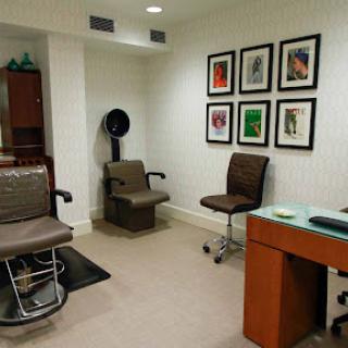 A modern waiting room with stylish chairs and framed artwork on the walls.