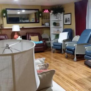 A cozy living room with comfortable chairs and homey decorations.