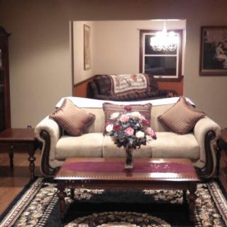 A traditional living room with a classic sofa, elegant coffee table, and stylish chandelier.