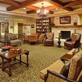 A cozy living room with a fireplace and comfortable seating.
