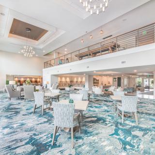 A modern, spacious dining area with elegant chandeliers and stylish furniture.