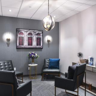 A modern waiting room featuring comfortable seating and stylish decor.