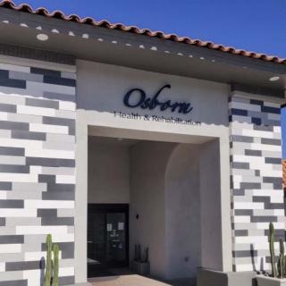 A modern building with signage and a tiled exterior.