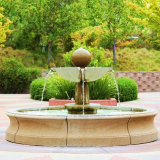 A beautiful fountain in a landscaped garden setting.