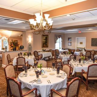 An elegant dining area with round tables set for a formal event.