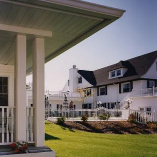 A beautiful residential home with a well-maintained lawn and classic architectural design.