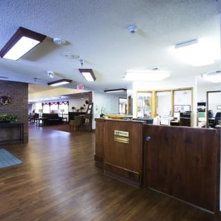 A spacious office lobby with a reception desk and seating area.