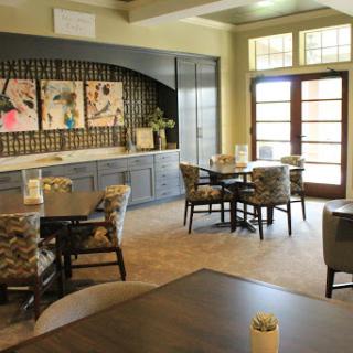A stylish lounge area featuring modern furniture and artwork, designed for comfort and relaxation.
