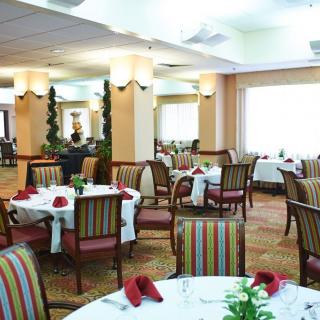 A well-arranged restaurant dining area with neatly set tables and chairs.