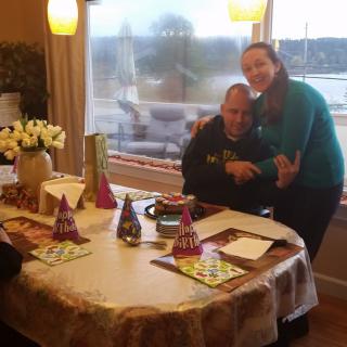 A joyful family gathering with party hats and a beautifully set table.