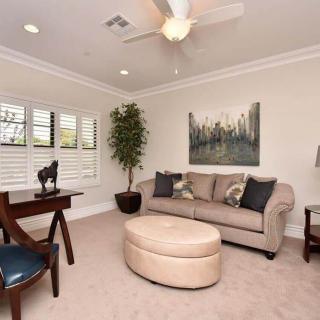 A cozy living room with a sofa, coffee table, and wall art.